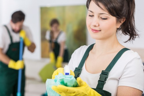 Cleaning staff maintaining a modern office interior in SE11